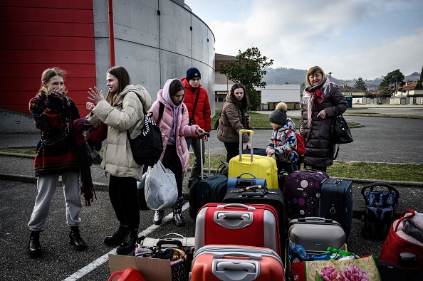 -Des réfugiés ukrainiens sont accueillis à leur arrivée en bus à Saint-Pierre-de-Chandieu, dans l'est de la France, le 3 mars 2022. Photo de JEFF PACHOUD/AFP via Getty Images.