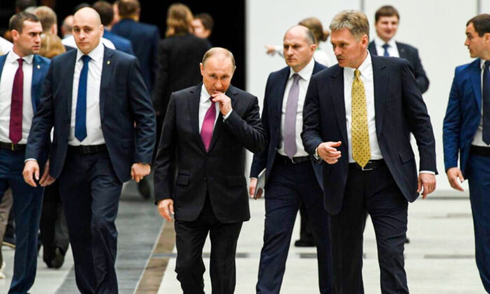 Le président russe Vladimir Poutine (au centre) s'entretient avec son secrétaire de presse Dmitri Peskov (2e à dr.). (Kirill Kudryavtsev/AFP via Getty Images)