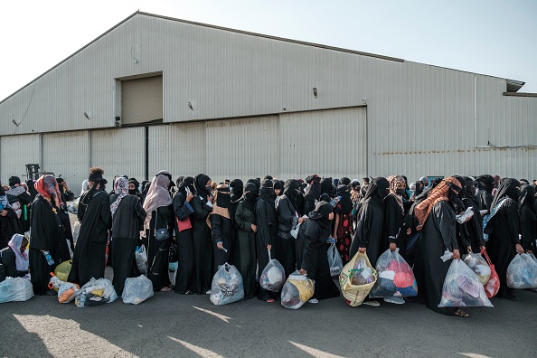 Des Éthiopiens rapatriés d'Arabie saoudite font la queue pour l'enregistrement lors de leur arrivée à l'aéroport de Bole, à Addis Abeba, le 30 mars 2022. (EDUARDO SOTERAS/AFP via Getty Images)