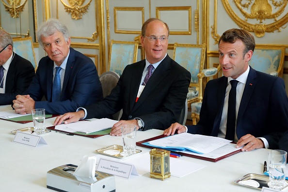 Larry Fink (au centre), PDG de BlackRock, participe à une réunion sur le changement climatique avec Emmanuel Macron et Yves Perrier (à gauche), directeur général du fonds de gestion d’actifs Amundi, organisée au palais de l’Élysée le 10 juillet 2019. 