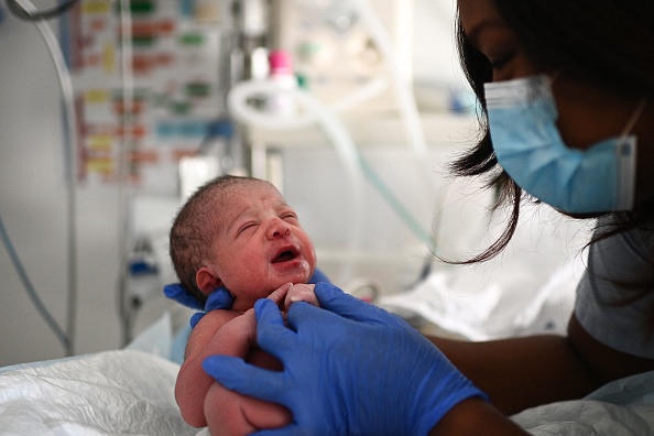 Une infirmière prend soin d'un nouveau-né quelques instants après sa naissance à la maternité d'un hôpital de Paris le 29 juin 2022..
(Photo  CHRISTOPHE ARCHAMBAULT/AFP via Getty Images)