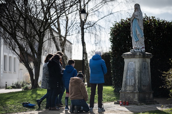 Des catholiques prient devant une statue de la Vierge Marie à Saint-Père-en-Retz 
(Loire-Atlantique), dans le cadre du mouvement La France prie. (LOIC VENANCE/AFP via Getty Images)