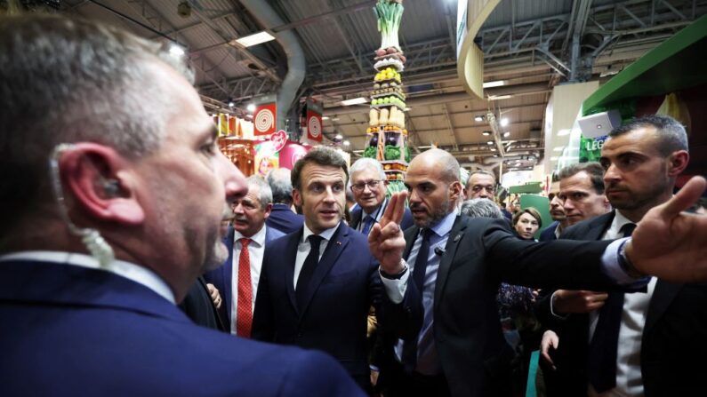 Le président français Emmanuel Macron (C) interagit avec des membres du public lors de sa visite du Salon international de l'agriculture à Paris le 25 février 2023. (Photo CHRISTOPHE PETIT TESSON/POOL/AFP via Getty Images