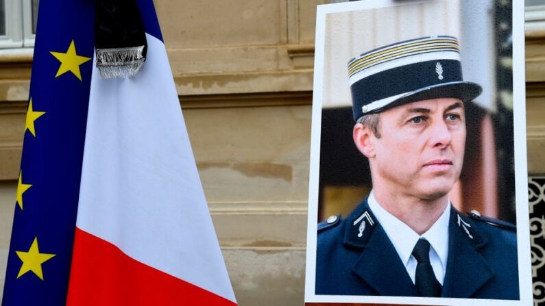 Un portrait du lieutenant-colonel français Arnaud Beltrame est présenté pendant une minute de silence, le 28 mars 2018 au ministère de l'Intérieur à Paris. (Crédit photo BERTRAND GUAY/AFP via Getty Images)