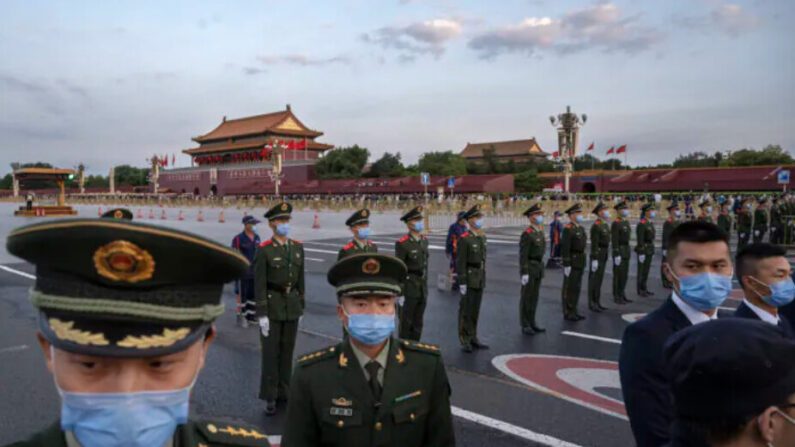 Des policiers et des agents de sécurité contrôlent la foule après une cérémonie officielle de lever du drapeau près de la place Tiananmen et de la Cité interdite à Pékin, en Chine, le 1er octobre 2021. (Kevin Frayer/Getty Images)