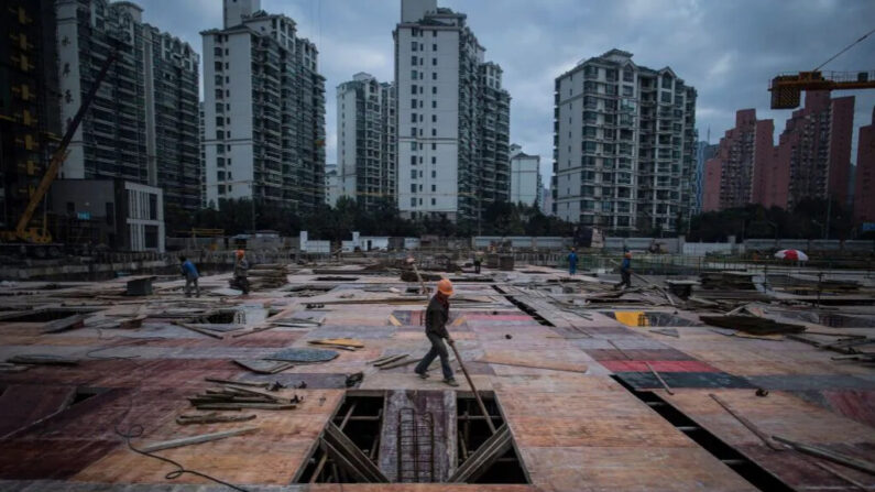 Un homme travaille sur un chantier de construction d'un gratte-ciel résidentiel à Shanghai le 29 novembre 2016. (JOHANNES EISELE/AFP via Getty Images)
