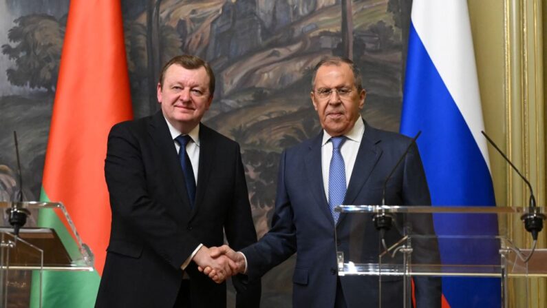 Le ministre russe des Affaires étrangères, Sergei Lavrov, et son homologue biélorusse, Sergei Aleinik, se serrent la main lors d'une conférence de presse commune à l'issue de leurs entretiens à Moscou, le 17 mai 2023. (NATALIA KOLESNIKOVA/POOL/AFP via Getty Images)