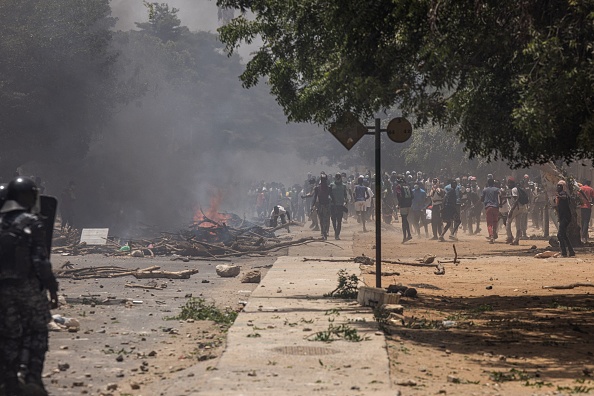 Des manifestants lancent des pierres et allument des feux à Dakar, le 1er juin 2023, lors d'une manifestation. (JOHN WESSELS/AFP via Getty Images)