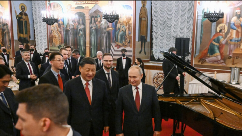 Le président russe Vladimir Poutine et le dirigeant chinois Xi Jinping quittent la salle après une réception organisée à l'issue de leurs entretiens au Kremlin, à Moscou, le 21 mars 2023. (Grigory Sysoyev/SPUTNIK/AFP via Getty Images)