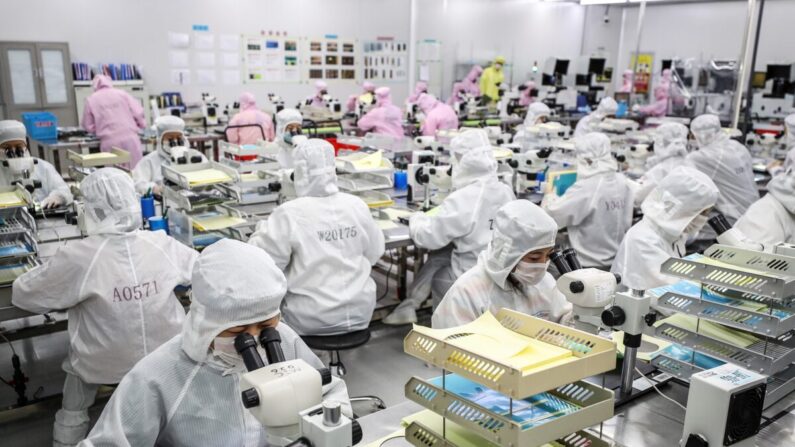 Des ouvriers produisent des puces LED dans une usine de Huaian, dans la province chinoise de Jiangsu (est), le 16 juin 2020. (STR/AFP via Getty Images)