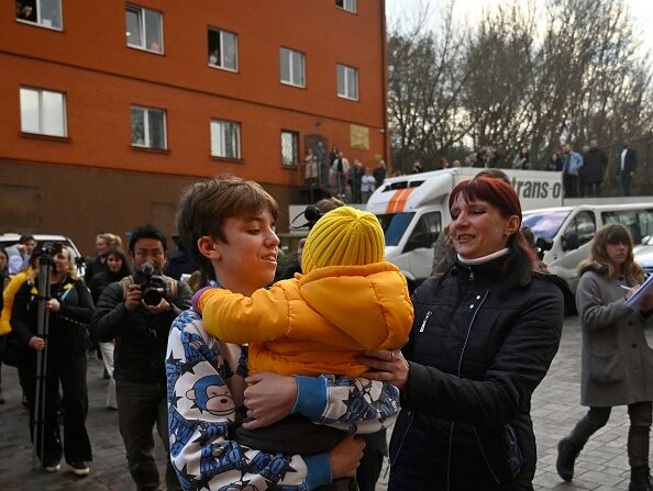 Inessa rencontre son fils Vitaly après l'arrivée à Kiev, le 22 mars 2023, du bus qui le ramenait avec plus d'une douzaine d'autres enfants des territoires tenus par les Russes. Illustration. (Photo SERGEI CHUZAVKOV/AFP via Getty Images)