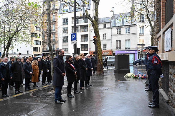 La Première ministre Élisabeth Borne (au c.) devant une plaque commémorative à Paris, le 13 novembre 2023, à l'occasion du huitième anniversaire des attentats de Paris du 13 novembre 2015. (Photo BERTRAND GUAY/POOL/AFP via Getty Images)