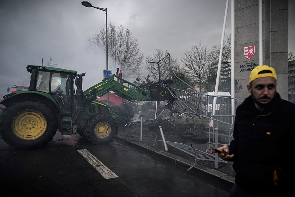 Un tracteur enlève les barrières devant le Conseil régional d'Aquitaine, à Bordeaux, le 11 mars 2024. (Photo PHILIPPE LOPEZ/AFP via Getty Images)