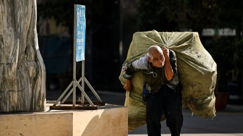 Un homme âgé porte un sac de matériaux recyclables sur son dos à Ruili, dans la province occidentale du Yunnan, en Chine, le 13 janvier 2023. (Noel Celis/AFP via Getty Images)