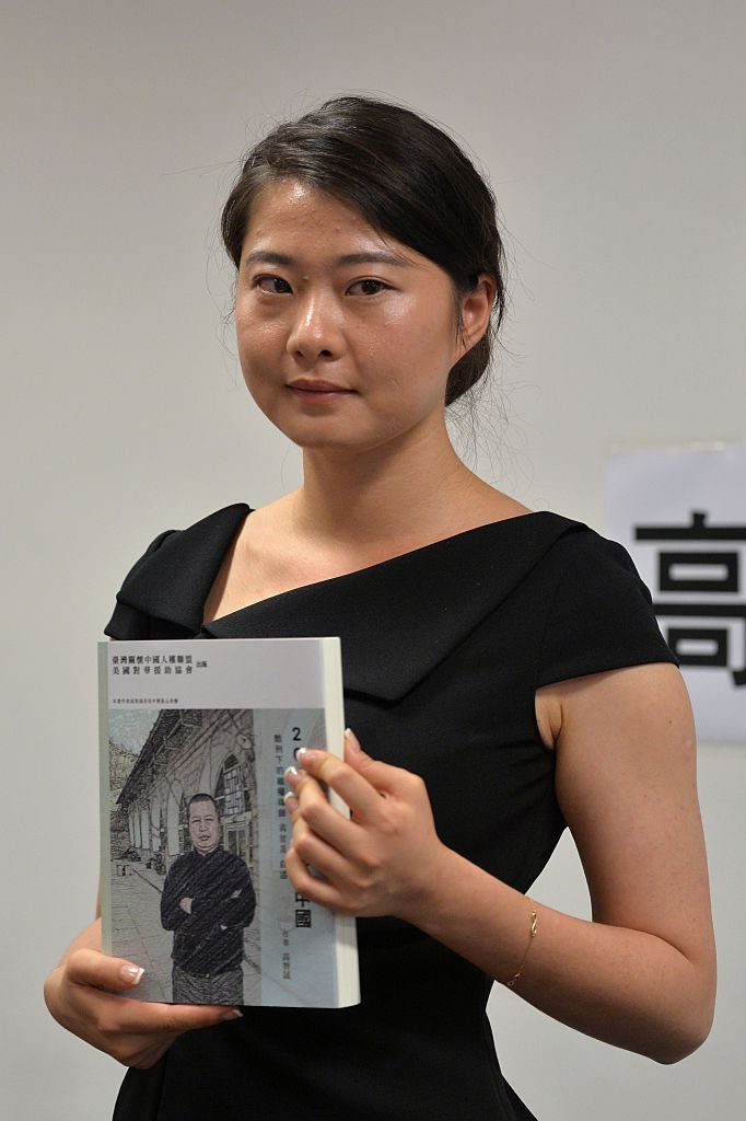Grace Geng, daughter of Gao Zhisheng, a renowned human rights lawyer in China, holds her father's book "A Human Rights Lawyer under Torture the auto narratives of Gao Zhisheng", during a press conference at the Legislative Council Complex in Hong Kong on June 14, 2016. A leading dissident lawyer in China is prepared to face the consequences over his new book predicting the possible collapse of the ruling Communist Party, his tearful daughter said June 14. Gao Zhisheng has been under house arrest since 2014 after serving a three-year prison term on subversion-related charges -- a sentence which sparked an international outcry. / AFP / ANTHONY WALLACE (Photo credit should read ANTHONY WALLACE/AFP/Getty Images)