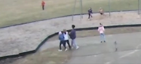 Screenshot from video released by Springfield, Ohio School District showing two Black students at Kenwood Elementary School forcibly escorting a white student to an area near near the swings.